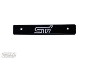 Subaru WRX STI License Plate Relocation - Turbo XS - Billet Aluminum with Machined STi Logo - Black - `08-`14 Subaru WRX STI License Plate Relocation - Turbo XS - Billet Aluminum with Machined STi Logo - Black - `08-`14